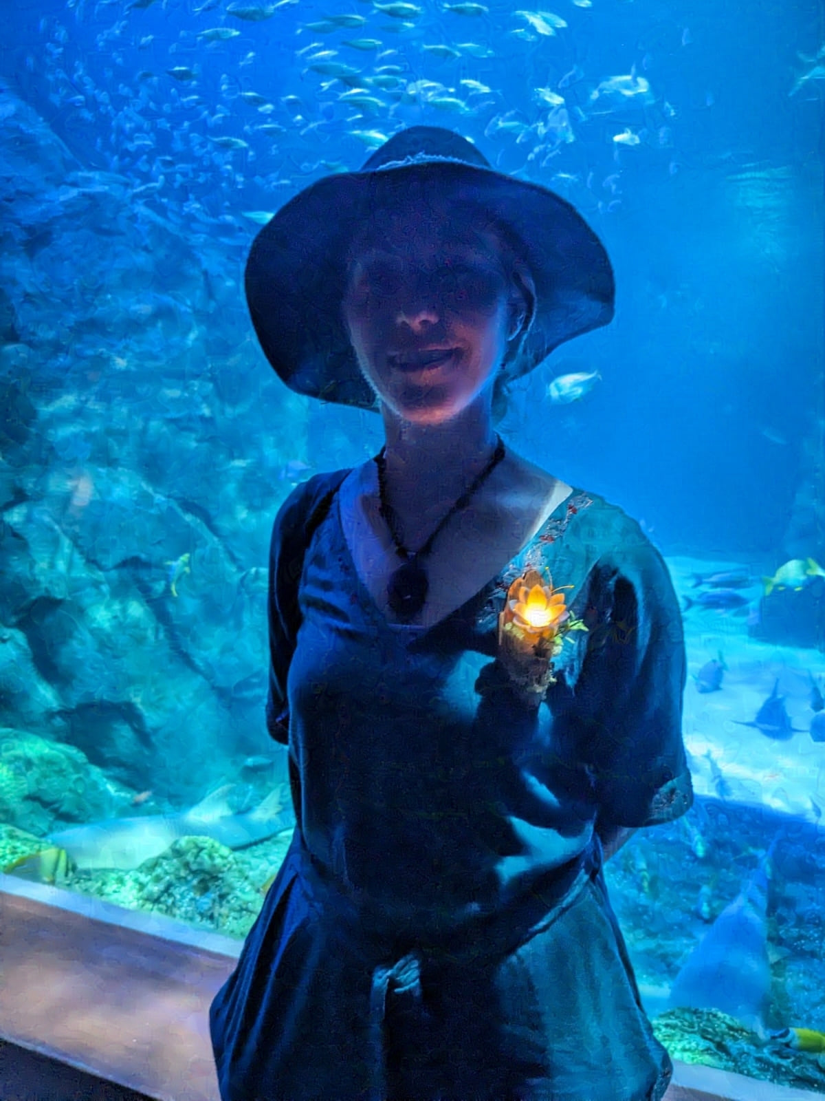 Our enchanted flowers look amazing in low light- karen wearing one at the aquarium